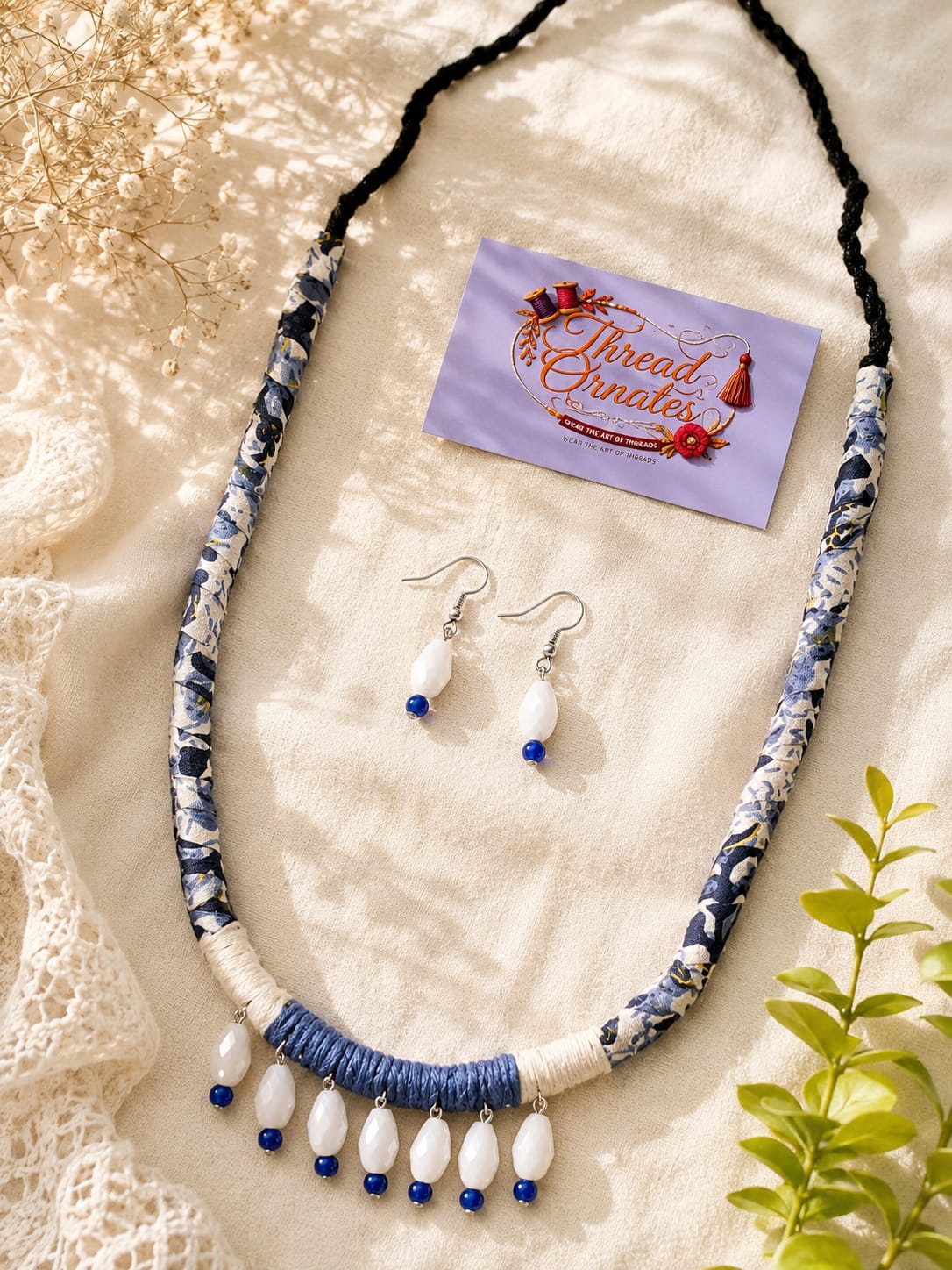 IVORY BLUE DRAPED CHARMS NECKLACE